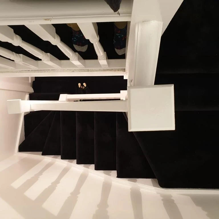 Black stair carpet installation
